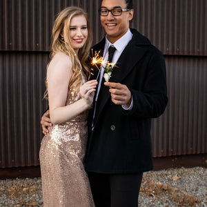 Man and woman holding 10 inch sparklers at New Year;s Eve party