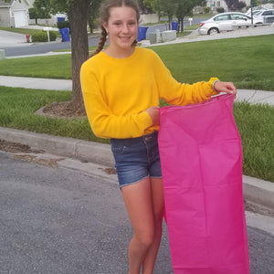 Girl holding pink biodegradable paper sky lantern