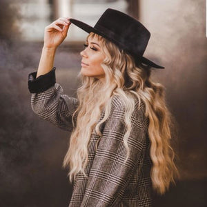 60-Second Color Smoke Bombs in black creating black smoke filled atmosphere behind lady in black hat and plaid jacket