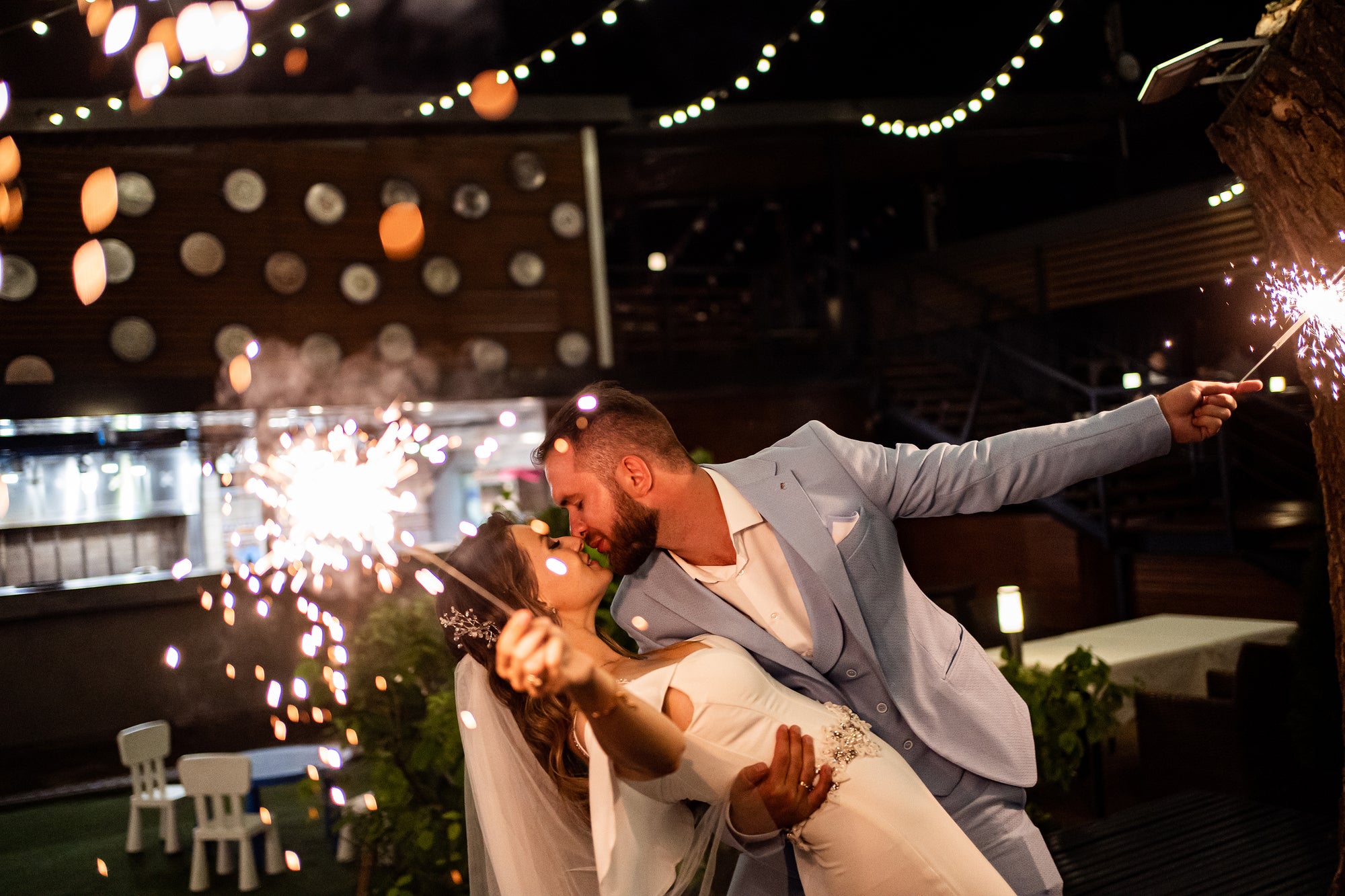 Extra long wedding sparklers being used at wedding send off