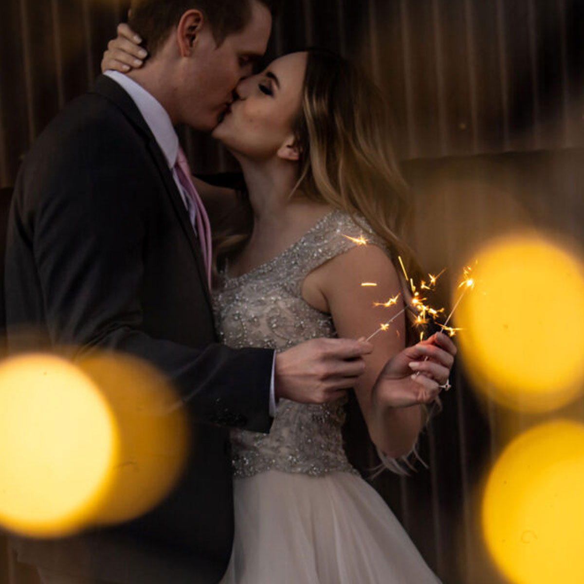 Close-up of a 10-inch gold sparkler emitting bright golden sparks, creating a festive atmosphere for celebrations and events.