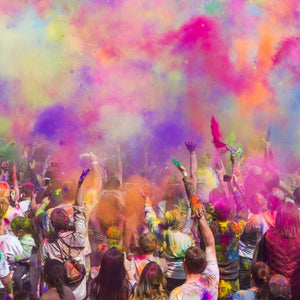 Holi festival of colors with people throwing color powder into air