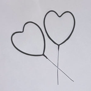 Two metal handle heart sparklers against bright white background