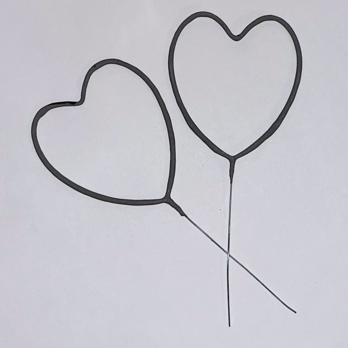 Pack of 36 heart sparklers against white background mesmerizing guests at wedding sendoff 